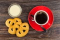 Cookies, coffee, spoon on saucer, condensed milk in bowl Royalty Free Stock Photo