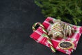 Cookies in the form of Christmas trees, on a red napkin, Lollipop, spruce branch on a black background Royalty Free Stock Photo