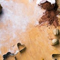 Cookies forms and gingerbread dough on wooden pastry board