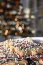 Cookies in front oaf a blurred Christmas tree Royalty Free Stock Photo