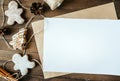 cookies in the form of Christmas trees, gingerbread man on a brown background, a white sheet in the handle, a place for the inscri