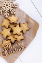 Cookies on kraft paper with wood snowflake and an inscription