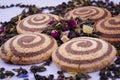 Cookies with a light and dark spiral with tea from flowers on a light background