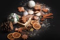 Gingerbread cookies with powdered sugar on black background.