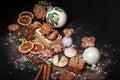 Gingerbread cookies with powdered sugar on black background.