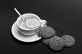 Cookies near tea on dark grey background. Sweet bakery and tea time. Oatmeal biscuits as tasty pastry Royalty Free Stock Photo