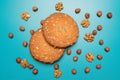 Cookies and nuts studio image. Tasty cookies with seeds on a background of nuts. Homemade cookies with set nuts on a blue ba