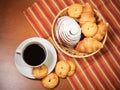 Cookies, pastries and coffee cup on wooden background