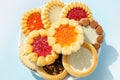 cookies on plate against blue background. round cookies laid out on saucer. copy space, top view Royalty Free Stock Photo