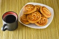 Cookies on a plate and a cup of black coffee. Royalty Free Stock Photo