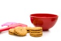 Cookies with Red Bowl and Red and Pink Spatula Isolated on White