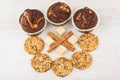 Cookies with sesame seeds, cupcakes, sugar and cinnamon sticks Royalty Free Stock Photo