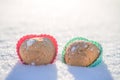 Cookies in the shape of hearts in the snow.