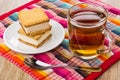 Cookies with souffle, cup with tea, spoon on napkin Royalty Free Stock Photo