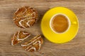Cookies with sunflower seeds and sesame, broken cookie, coffee in cup on saucer on wooden table. Top view
