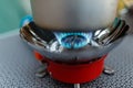 Cooking in an aluminum pot meals on a portable gas burner on a background of camping in the woods. Close-up of portable gas burner Royalty Free Stock Photo