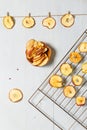 Dried apples on the grill, slices of apples hung on a rope and ready-made apple chips in a bowl. Top view, vertical Royalty Free Stock Photo