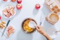 Cooking apple pie process: woman add sugar into bowl Royalty Free Stock Photo