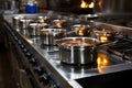 Cooking array Stainless steel pots on display atop the restaurant stove Royalty Free Stock Photo