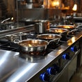 Cooking array Stainless steel pots on display atop the restaurant stove Royalty Free Stock Photo