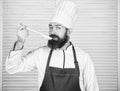 Cooking as professional occupation. Hipster bearded chef hold wooden spoon. Kitchenware and cooking concept. Lets try Royalty Free Stock Photo