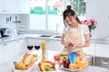 Cooking asian woman housewife in the kitchen making healthy food Royalty Free Stock Photo