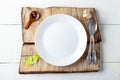 Cooking background concept. Empty white plate, spice and cutlery