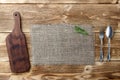 Cooking background concept. Vintage cutting board, sackcloth and cutlery. Top view.