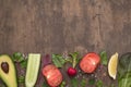 Cooking background with fresh vegetables and herbs. Ingredients for salad on brown table, top view, copy space, flat lay Royalty Free Stock Photo