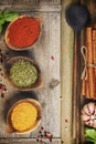 Cooking background with herbs, spices and rustic kitchen utensils, top view Royalty Free Stock Photo