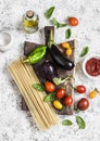 Cooking background. Raw ingredients for making pasta - spaghetti, eggplant, tomatoes, pepper, olive oil, tomato sauce and basil on Royalty Free Stock Photo