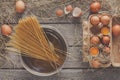 Cooking background. Vermicelli and eggs in carton, top view on r
