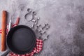 Cooking or baking food background with kitchen utensils, rolling pin, frying pan, cookie cutout on grey wooden background Royalty Free Stock Photo