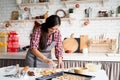 Young brunette woman baking cookies at the kitchen