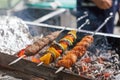 Cooking barbecue on a metal skewer. Mangal with skewered shish kebabs.