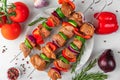 Cooking barbeque, kebab or shashlik. Raw pork meat with vegetables, pepper and onion on skewers. Top view Royalty Free Stock Photo