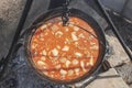 Cooking bean in a caldron on open flame Royalty Free Stock Photo