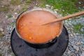 Cooking bean goulash in a caldron on open flame Royalty Free Stock Photo