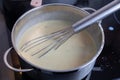 Cooking of bechamel sauce in a pot.