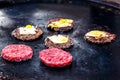 Cooking beef and pork patty with eggs and cheese for burger. Meat roasted on fire barbecue kebabs on the grill. Royalty Free Stock Photo