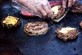 Cooking beef and pork patty with eggs and cheese for burger. Meat roasted on fire barbecue kebabs on the grill. Grilled burger cut
