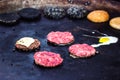 Cooking beef and pork patty with eggs and cheese for burger. Meat roasted on fire barbecue kebabs on the grill. Grilled burger cut Royalty Free Stock Photo