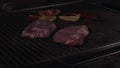 Cooking Beef steak on the grill grate on restrain kitchen, close up