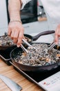 Cooking black pasta with seafood in a cooking class. Italian pasta with seafood. Mussels, squid, shrimp. Homemade food Royalty Free Stock Photo