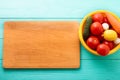 Cooking board and fresh vegetables on blue wooden background. Top view and copy space. Mock up Royalty Free Stock Photo