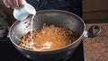 Cooking bolognese sauce for pasta: pouring milk Royalty Free Stock Photo