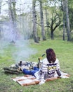 Cooking breakfast on a campfire at a summer camp. Royalty Free Stock Photo