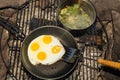 Cooking Breakfast over the campfire Royalty Free Stock Photo