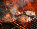 Cooking burgers on hot grill with flames