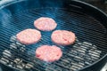 Cooking burgers on hot grill with flames Royalty Free Stock Photo